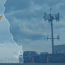 The state of Delaware, with outlined county borders and a star; a cell tower.