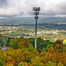 U.S. Congressman Rob Bresnahan with FirstNet Authority personnel, local first responders, public safety officials, and community leaders standing in front of new FirstNet cell tower site; aerial view of the new, rural tower in Luzerne County, Pennsylvania