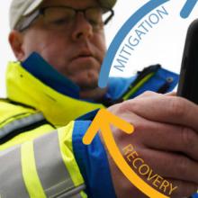 First responder holding a smartphone. Symbol of emergency management cycle. 