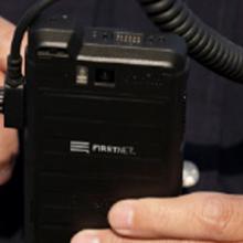 A first responder using FirstNet Push-to-Talk on a ruggedized smartphone