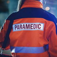 A paramedic stands near an incident scene