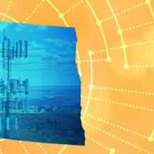 The silhouette of the State of North Dakota revealing a cell tower inside; radiating connectivity illustration