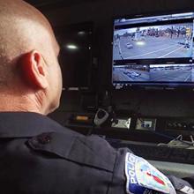 An male officer with the Richmond (Va.) Police Department monitors information n a computer screen.