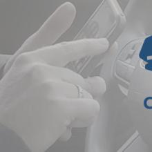 A police officer using a smartphone in the front seat of a patrol vehicle A police officer using a smartphone in the front seat of a patrol vehicle