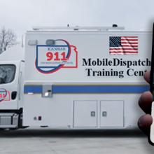 A mobile dispatch vehicle “Kansas 911” “Mobile Dispatch Training”; a hand holding a mobile phone showing a location app; a telecommunicator on the phone at a workstation