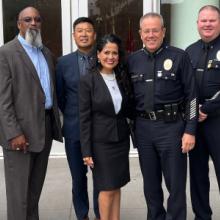A group of FirstNet Authority, LAPD, and AT&T personnel posed in front of an LAPD office A group of FirstNet Authority, LAPD, and AT&T personnel posed in front of an LAPD office