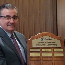 John Stevens receives the Chief Harlin R. McEwen Public Safety Broadband Communications Award from Board Vice Chair Richard Carrizzo 