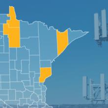 The state of Minnesota, with outlined county borders; a cell tower.