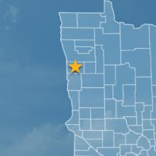 State of Minnesota with counties outlined; a star marking Norman County; a cell tower 