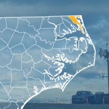 The state of North Carolina, with outlined county borders; a cell tower.