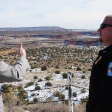 A public safety officer and a FirstNet Authority staff member speak with each other overlooking a Navajo reservation