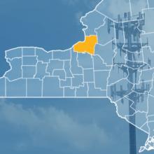 The state of New York, with outlined county borders; a cell tower.