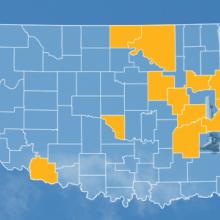 The state of Oklahoma, with outlined county borders; a cell tower