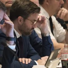 PSAC Spring Business Meeting highlights FirstNet network innovation, expansion; FirstNet Authority logo; PSAC members seated at a table in a meeting