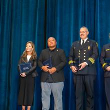 Six 2025 Patriot Award winners stand on stage after receiving their award