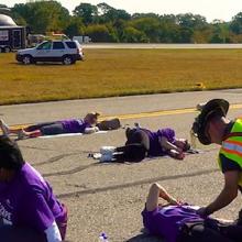 During a large-scale incident at an airport, first responders are attending crash victims on runway.