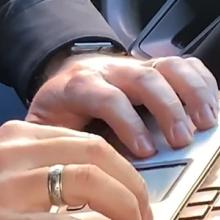 A law enforcement officer types on a computer.    