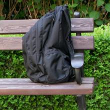 A backpack on a bench in a park