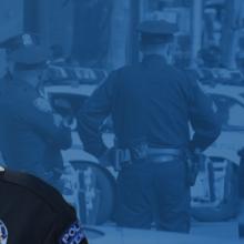 Sylvia Moir headshot, a group of four police officers checking cars at a routine traffic stop in a busy city street Sylvia Moir headshot, a group of four police officers checking cars at a routine traffic stop in a busy city street