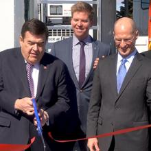 Congressman C.A. Dutch Ruppersberger cuts a red ribbon as FirstNet Authority Acting CEO Ed Parkinson looks on in front of an AT&T Satellite Cell on Light Truck