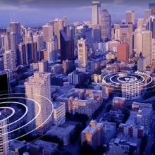 A graphic representation of signals spreading out across a major city with skyscrapers and many buildings