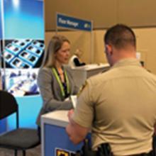 Edward Parkinson speaks to CES attendees; Bill Schrier gives a presentation; Chrissie Coon gives a presentation; two police offers visit the FirstNet exhibit booth; CES logo Edward Parkinson speaks to CES attendees; Bill Schrier gives a presentation; Chrissie Coon gives a presentation; two police offers visit the FirstNet exhibit booth; CES logo
