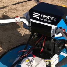 A flying COW with the AT&T FirstNet logo sits on the ground ready to launch