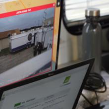 A first responder watches a video feed on a computer during an incident.