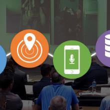 Six icons representing the Roadmap domains connected by a line over an image of two FirstNet Authority staff speaking to an audience of law enforcement and fire services representatives.