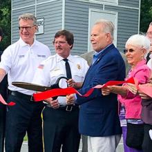 Maryland Delegate Johnny Mautz, FirstNet Authority Board Member David Zolet and others cut a red ribbon to celebrate a new cell site in Tilghman Island