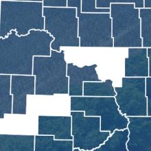 County map of North Dakota with Slope, McClean and Stark counties highlighted, FirstNet tower near a field