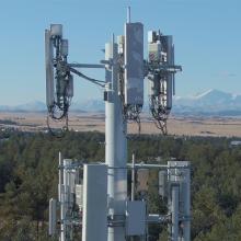 Three keys to success for FirstNet 3.0 Cellular tower with forest and mountain landscape in backdrop