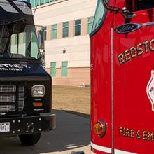 A Redstone Arsenal fire truck faces a FirstNet Emergency Mobile Communications Vehicle