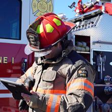 A Wayne County firefighter uses a tablet