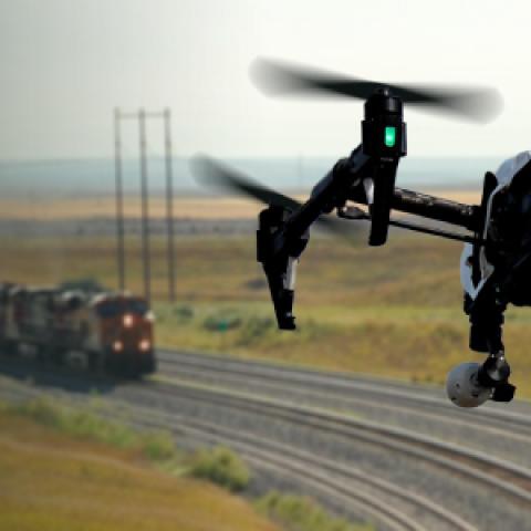Drone flying over moving train 
