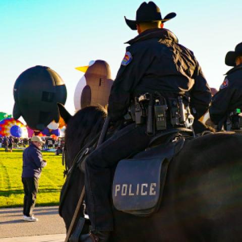 Group of New Mexico police officers riding on horseback monitoring the annual Albuquerque International Balloon Fiesta.