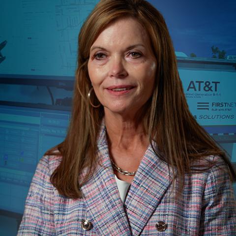 Michele Abbott speaking during an interview overlayed in front of a FirstNet mobile command unit interior on the left and exterior on the right. 