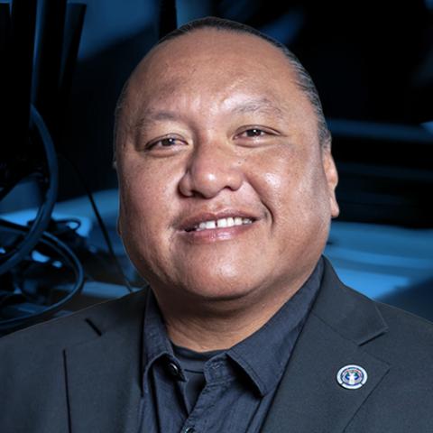 Joey DelaCruz appears on right side, behind is demonstration given in the CNMI of public safety equipment running on FirstNet. 