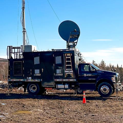 Solar eclipse totality over a lake near Jackman, Maine. A SatCOLT on a mountaintop surrounded by patches of snow in Maine. 