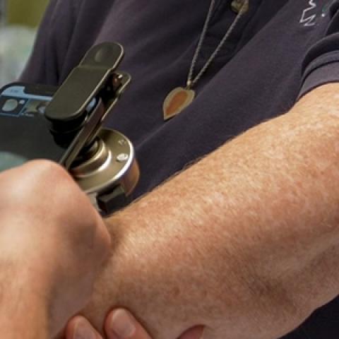 Jackman paramedic using a telemedicine application on a FirstNet-enabled smartphone while tending to a patient