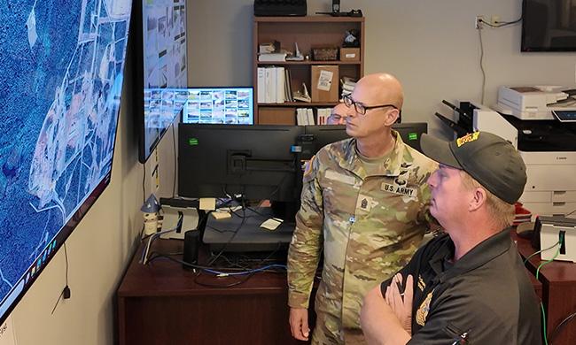 Public safety staff at Redstone Arsenal view a map on a screen showing asset locations