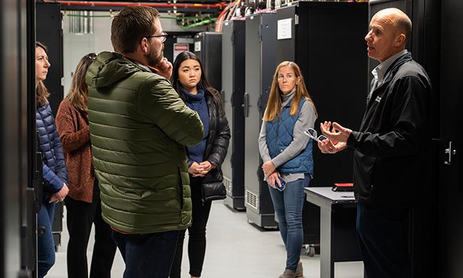 A FirstNet Authority staff member guides a tour of the FirstNet Boulder Lab