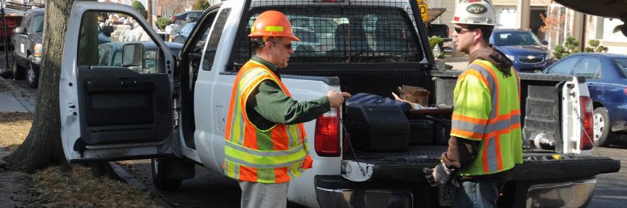 Department of Transportation inspectors monitoring debris removal 