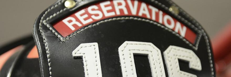 A firefighter's helmet that says "reservation" on the top