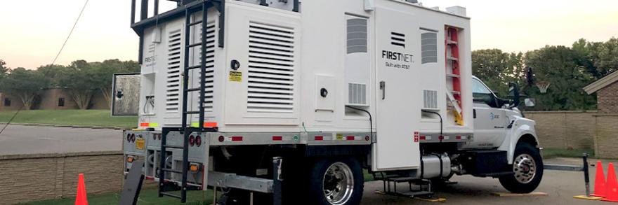 A SalColt parked outside next to a brick fence and cones