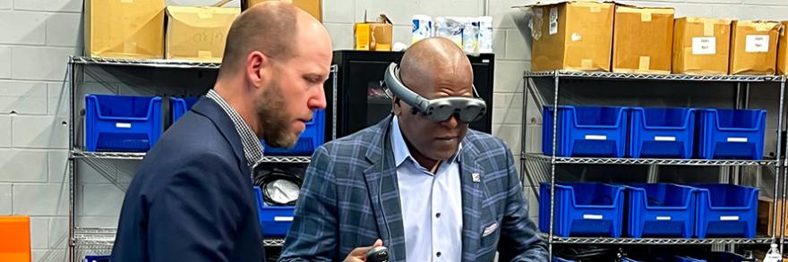 The First Responder Network Authority board chair Stephen Benjamin wearing a pair of virtual reality goggles during a lab tour.