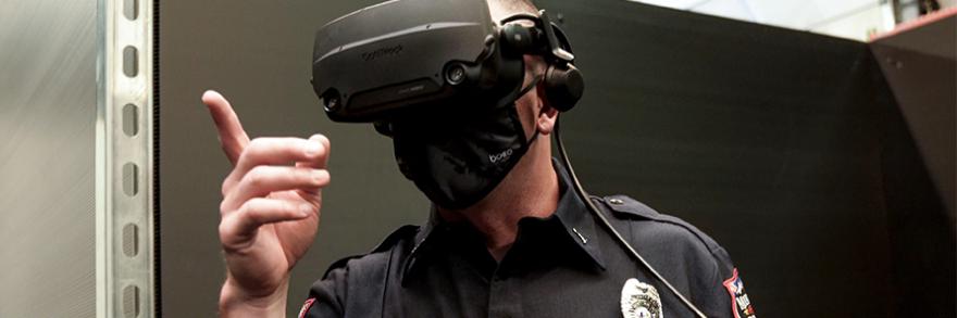 Close view of first responder wearing virtual reality glasses pointing forward.