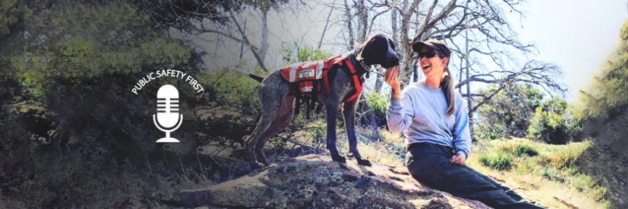 First responder in the woods with her search and rescue dog