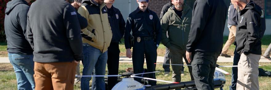 Attendees at the New England Drone Competition watch a demo of an AT&T drone