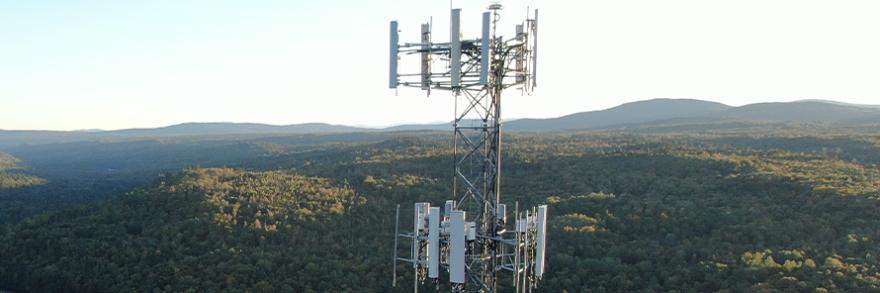 A FirstNet tower in rural woodlands provides coverage to rural first responders.